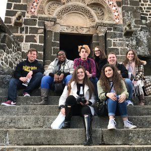 students from chamber choir at saint rose posing in france outside