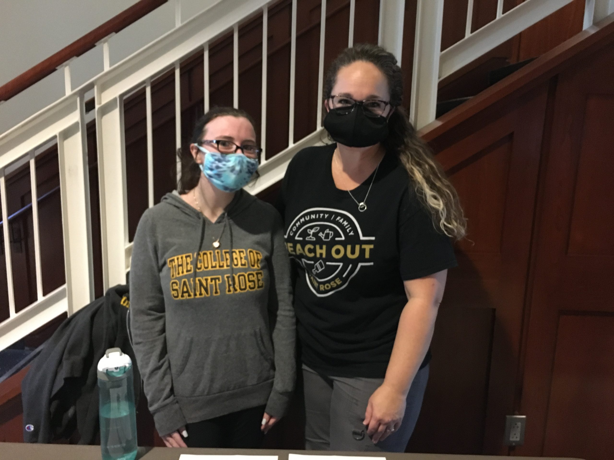A Saint Rose student is seen here with Amanda Bastiani, Title IX Coordinator and Director of Prevention Education and Success, at our annual Reach Out Saint Rose event. Both Amanda and the student are wearing masks and Saint Rose shirts.